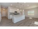 Modern kitchen with white cabinets, granite countertops, and an island at 1209 Red River Dr, Salisbury, NC 28144