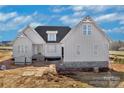 New construction exterior with white siding, brick foundation, and ladder leaning on the right at 2059 Parks Rd, Salisbury, NC 28147