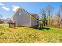 The backyard of this home features a large lawn with a deck and covered area at 2640 Ironwood Dr, Hickory, NC 28602
