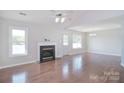 Spacious living room featuring hardwood floors, a fireplace, and natural light at 217 Dewars Dr, Rock Hill, SC 29730