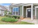 Front entrance of a charming craftsman style home, showcasing a dark brown door and landscaping at 3735 Norman View Dr, Sherrills Ford, NC 28673