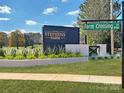 Elegant community entrance sign for Stephens Farm, featuring manicured landscaping and a contemporary design at 8115 Farm Crossing Ln # 3, Huntersville, NC 28078
