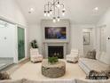 Cozy living room featuring a fireplace and large windows at 8115 Farm Crossing Ln # 3, Huntersville, NC 28078