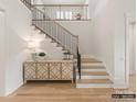 Elegant staircase with a modern metal railing and hardwood steps at 8115 Farm Crossing Ln # 3, Huntersville, NC 28078
