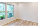 Bright room showcasing light wood flooring and large windows, offering ample natural light at 649 Kitfox Nw Dr, Concord, NC 28027
