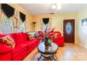 Bright living room featuring red couch and wood floors at 713 Perkins St, Lowell, NC 28098