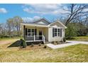 Charming home featuring black shutters, a cozy front porch and well-maintained landscaping at 414 Clinton Ave, Lancaster, SC 29720