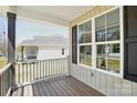 This charming front porch features wood floors, white trim, and a beautiful view at 414 Clinton Ave, Lancaster, SC 29720