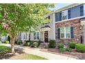 Front of townhome showcasing architectural details and landscaping at 11712 Blessington Rd, Huntersville, NC 28078