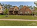 Beautiful two-story home featuring a well-maintained lawn, stone accents, and inviting curb appeal at 16827 Monocacy Blvd, Huntersville, NC 28078