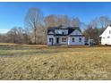 New construction home featuring a modern design, covered porch, and bright windows in a large lot at 552 Fern Hill Rd # 21, Mooresville, NC 28117