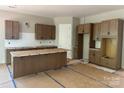 Unfinished kitchen featuring wood cabinets, an island, and subway tile backsplash at 552 Fern Hill Rd # 21, Mooresville, NC 28117