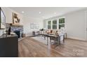 Spacious living room with stone fireplace, hardwood floors, and large windows at 219 E Warfield Dr, Mooresville, NC 28115
