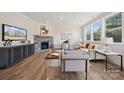 Bright living room featuring a stone fireplace and hardwood floors at 219 E Warfield Dr, Mooresville, NC 28115