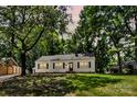 Charming home featuring a well-manicured lawn and mature trees providing ample shade and curb appeal at 1003 Woodland Dr, Gastonia, NC 28054