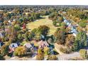 Aerial view of a home situated near a golf course with mature trees and manicured lawns at 15909 Woodcote Dr, Huntersville, NC 28078