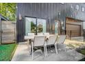 Outdoor patio featuring a dining table, string lights, and a sleek, modern design at 2107 W Trade St, Charlotte, NC 28216