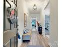Welcoming entryway with wood floors, bench, and a view into the home at 2413 Riparian Way, Denver, NC 28037