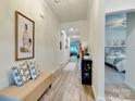 Bright entryway with bench and decor, leading to living areas and bedrooms at 2413 Riparian Way, Denver, NC 28037