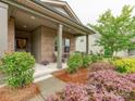 Inviting front porch with stylish columns and beautiful landscaping at 2413 Riparian Way, Denver, NC 28037