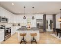 Modern kitchen featuring white cabinets, a large island, and stainless steel appliances at 4114 Rutgers Ave, Charlotte, NC 28206