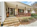 Inviting front porch with brick steps, a railing, and a screen door, enhanced by decorative fall decor at 2511 Old Pond Dr, Lincolnton, NC 28092