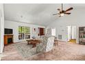 Spacious living room with a decorative fireplace, large windows, and neutral-toned furniture for a cozy feel at 2511 Old Pond Dr, Lincolnton, NC 28092