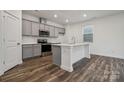 Modern kitchen with gray cabinets, stainless steel appliances, and an island at 318 Bezelle Ave, York, SC 29745