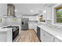 Modern kitchen featuring white cabinets and stainless steel appliances at 3327 Deerwood Dr, Gastonia, NC 28054