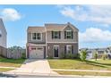 Two-story house with attached garage and American flag at 1197 Tangle Ridge Se Dr, Concord, NC 28025