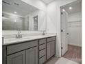 Double vanity bathroom with gray cabinets and a walk-in shower at 327 Bezelle Ave, York, SC 29745