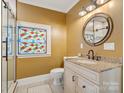 Modern bathroom with granite vanity and a frameless glass shower at 316 W Kingston Ave, Charlotte, NC 28203