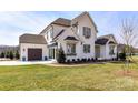 Charming two-story home with manicured lawn, a dark garage and white exterior at 5704 Crescent Field Cir # 25, Huntersville, NC 28078