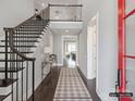 Bright, spacious foyer with elegant staircase, stylish console table, and warm, inviting ambiance at 5704 Crescent Field Cir # 25, Huntersville, NC 28078