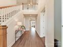 Grand foyer featuring hardwood floors, staircase, and elegant lighting fixture at 8111 Farm Crossing Ln # 2, Huntersville, NC 28078