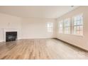 Spacious living room featuring hardwood floors and a corner fireplace at 4456 Doyle Ridge Rd, Maiden, NC 28650