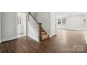 Bright foyer features hardwood flooring, a staircase, and access to a bathroom and the main living area at 9916 Manor Vista Trl, Kannapolis, NC 28027