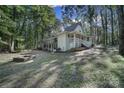 Two-story house with wrap-around porch, fire pit, and wooded lot at 17929 Pages Pond Ct, Davidson, NC 28036