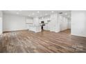 Modern white kitchen with an island and hardwood floors at 311 Bezelle Ave, York, SC 29745