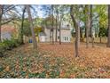 Spacious backyard with tree coverage and a large grassy area at 6920 Wyndbend Ln, Mint Hill, NC 28227