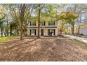 Two-story house with beige siding, black shutters, and a covered porch at 6920 Wyndbend Ln, Mint Hill, NC 28227