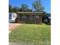 Charming exterior of home with a covered front porch and well-maintained lawn at 102 Elm St # 94, New London, NC 28127