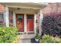 Two red doors with a wreath and potted plants at 1201 Green Oaks Ln # G, Charlotte, NC 28205