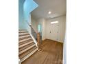 Light-filled entryway with hardwood floors and staircase at 3018 Cunningham Farm Dr, Indian Trail, NC 28079