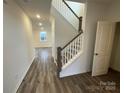 Bright entryway featuring hardwood floors and a classic staircase design at 3018 Cunningham Farm Dr, Indian Trail, NC 28079