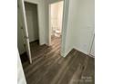 Hallway shot showing wood floors leading to a toilet room and closet at 3018 Cunningham Farm Dr, Indian Trail, NC 28079