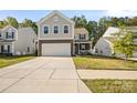 Charming two-story home with stone accents, a two-car garage, and a well-manicured front lawn in a neighborhood at 3020 Pinehills Way, Mount Holly, NC 28120