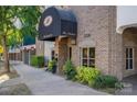 The Madison building entrance with brick facade and awning at 520 E Martin Luther King Blvd # 1204, Charlotte, NC 28202