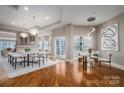 Elegant dining room with hardwood floors and a modern chandelier at 520 E Martin Luther King Blvd # 1204, Charlotte, NC 28202