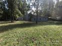 Large backyard with grassy area and mature trees at 6001 Long Pine Dr, Charlotte, NC 28227